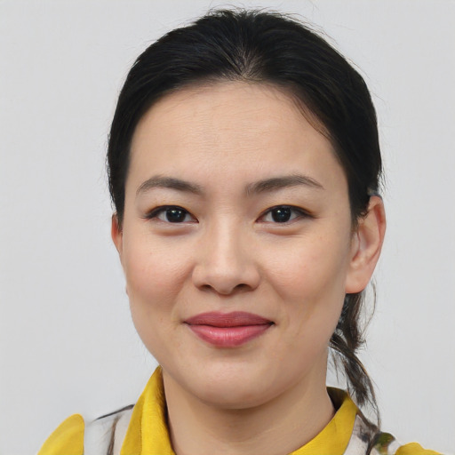 Joyful asian young-adult female with medium  brown hair and brown eyes