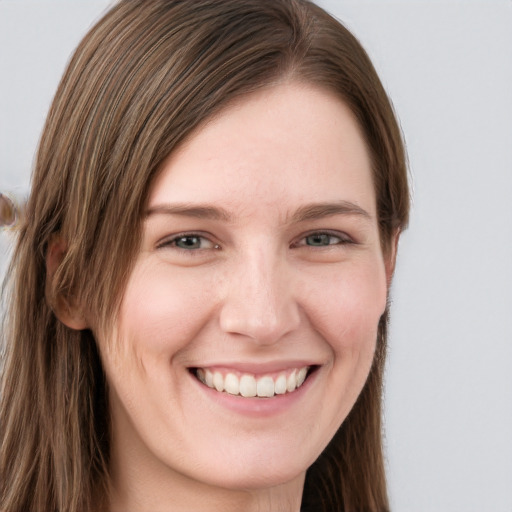 Joyful white young-adult female with long  brown hair and blue eyes