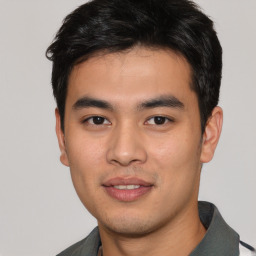 Joyful asian young-adult male with short  black hair and brown eyes