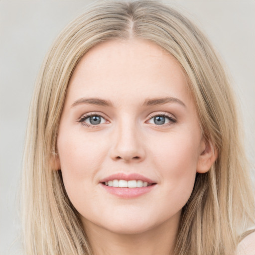 Joyful white young-adult female with long  brown hair and blue eyes