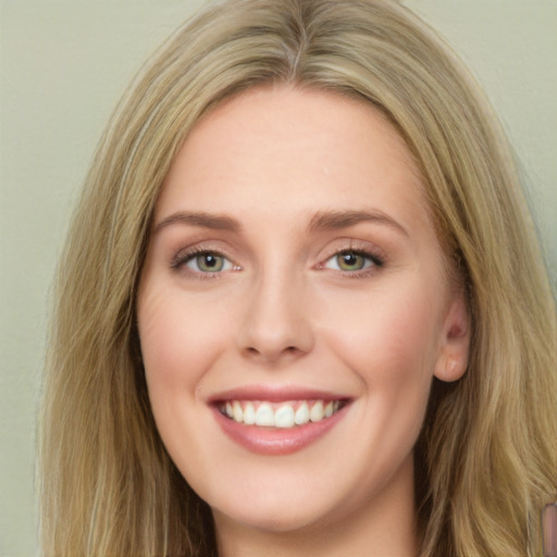 Joyful white young-adult female with long  brown hair and green eyes