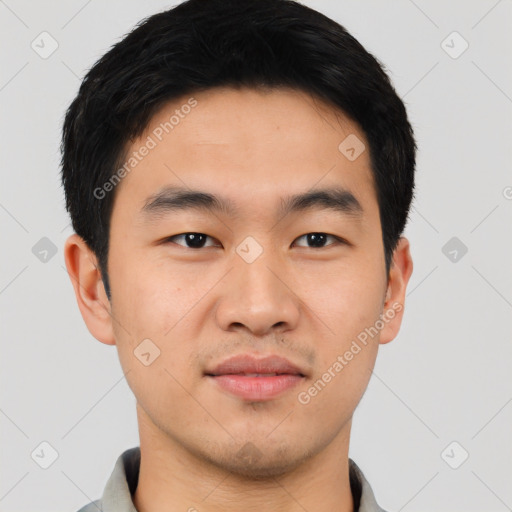 Joyful asian young-adult male with short  black hair and brown eyes