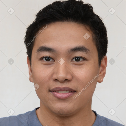 Joyful asian young-adult male with short  black hair and brown eyes