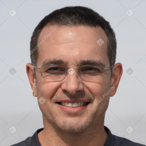 Joyful white adult male with short  black hair and brown eyes