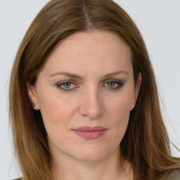 Joyful white young-adult female with long  brown hair and green eyes