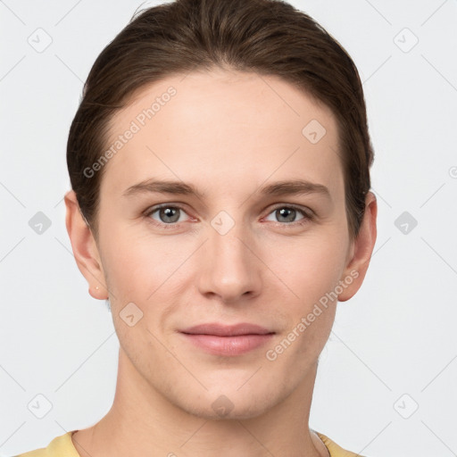 Joyful white young-adult female with short  brown hair and grey eyes