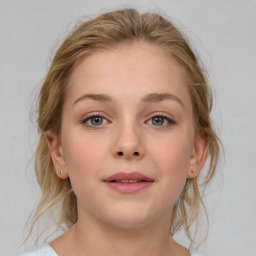 Joyful white child female with medium  brown hair and grey eyes