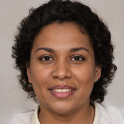 Joyful black adult female with medium  brown hair and brown eyes