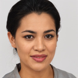 Joyful latino young-adult female with medium  brown hair and brown eyes