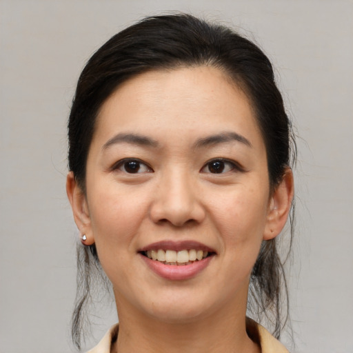 Joyful asian young-adult female with medium  brown hair and brown eyes