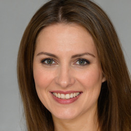 Joyful white young-adult female with long  brown hair and green eyes