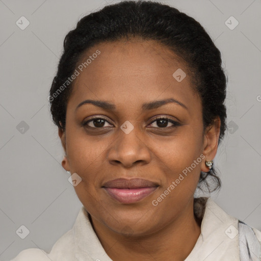 Joyful black adult female with short  black hair and brown eyes