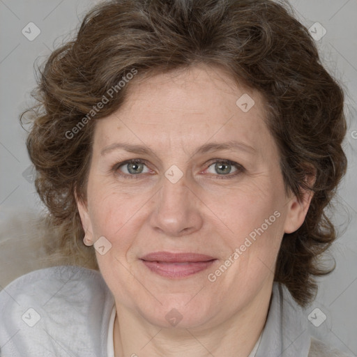 Joyful white adult female with medium  brown hair and blue eyes