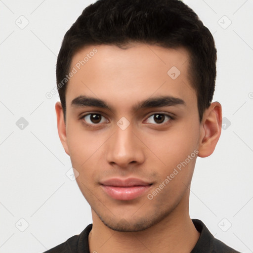 Joyful latino young-adult male with short  brown hair and brown eyes