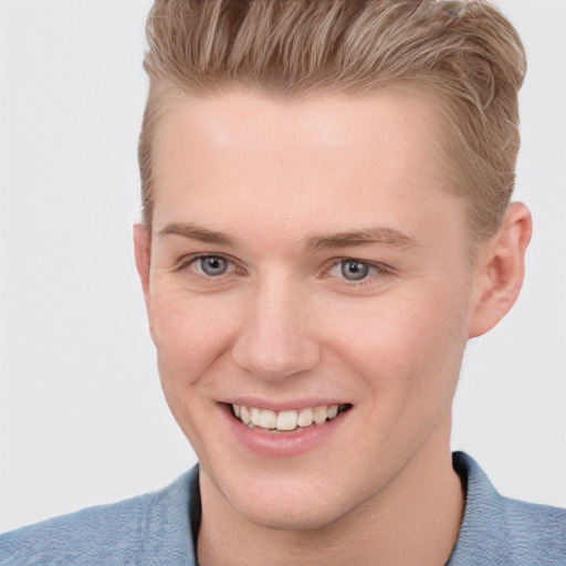 Joyful white young-adult male with short  brown hair and blue eyes