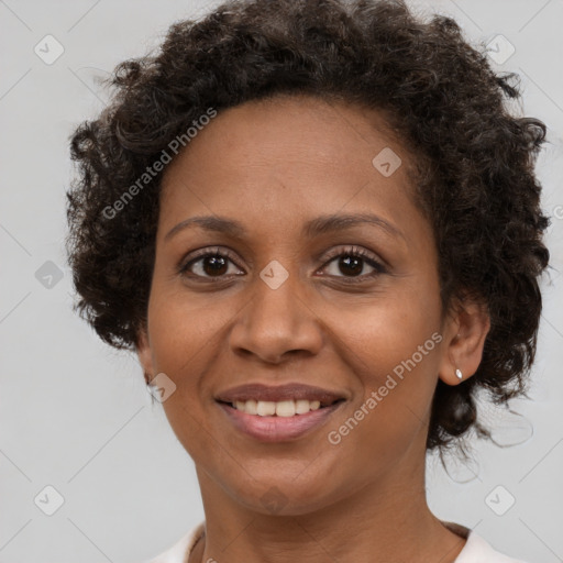 Joyful black adult female with medium  brown hair and brown eyes