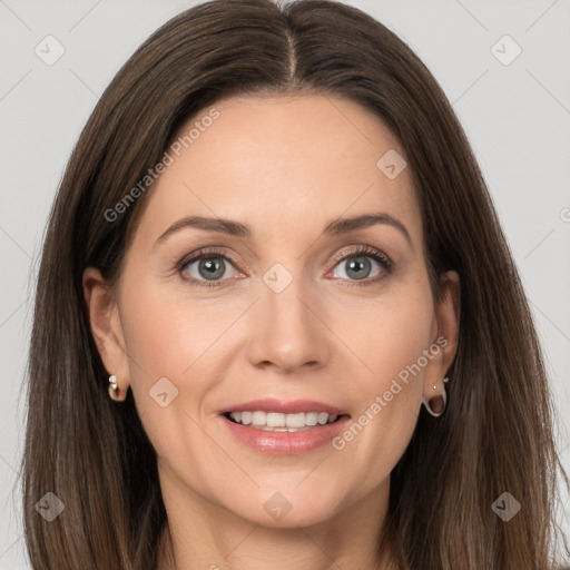 Joyful white adult female with long  brown hair and grey eyes