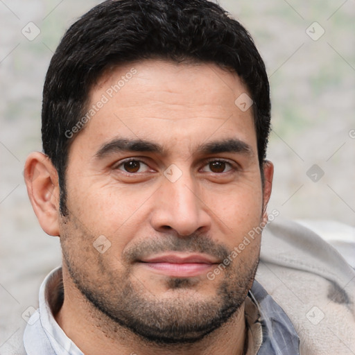 Joyful white young-adult male with short  black hair and brown eyes