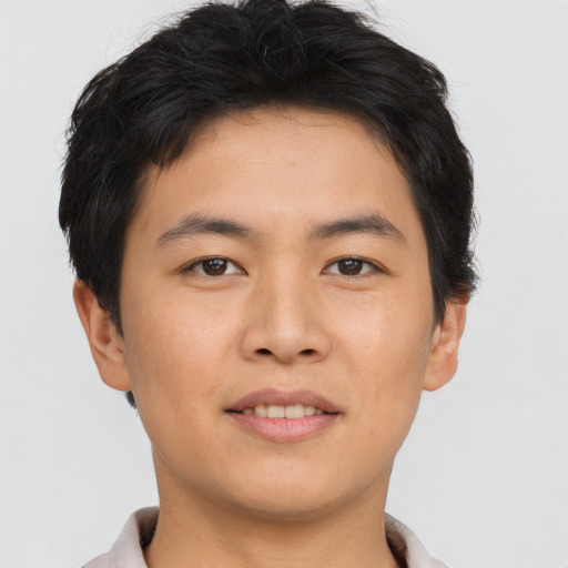 Joyful asian young-adult male with short  brown hair and brown eyes