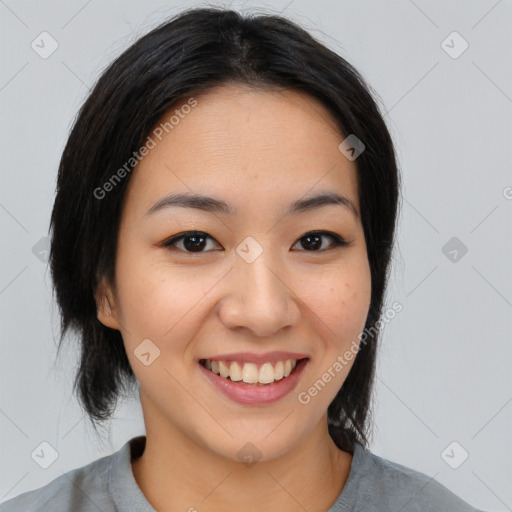 Joyful asian young-adult female with medium  black hair and brown eyes