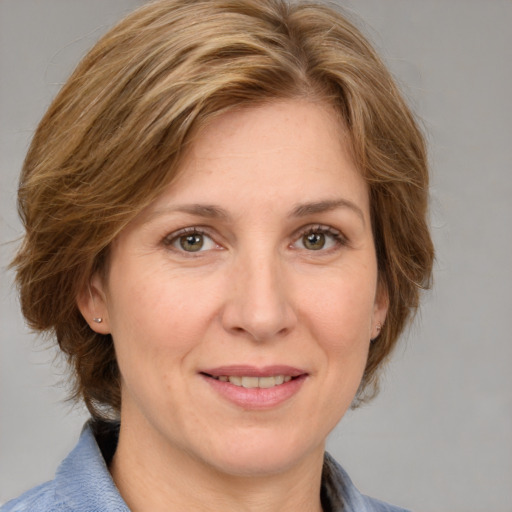 Joyful white adult female with medium  brown hair and grey eyes