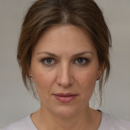 Joyful white adult female with medium  brown hair and brown eyes