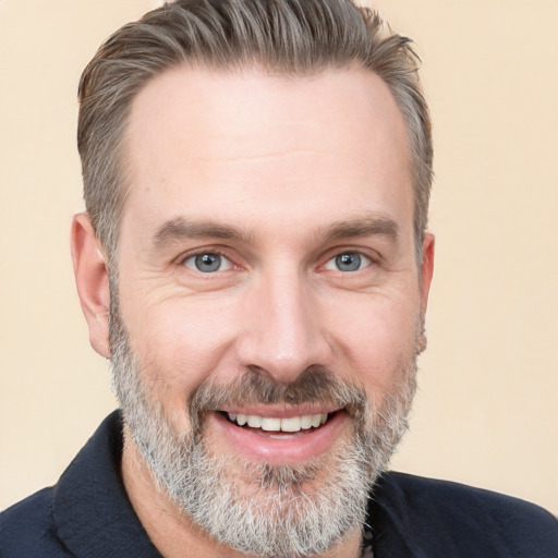 Joyful white adult male with short  brown hair and brown eyes