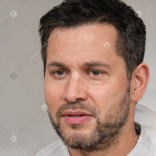 Joyful white adult male with short  brown hair and brown eyes