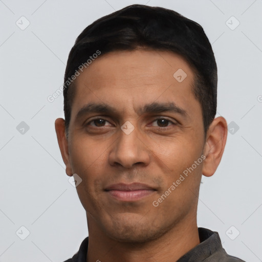 Joyful latino young-adult male with short  black hair and brown eyes