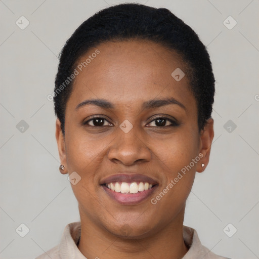 Joyful black young-adult female with short  black hair and brown eyes