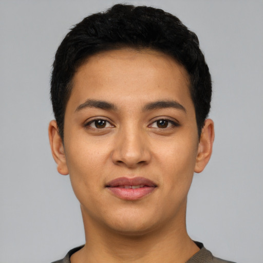 Joyful latino young-adult male with short  black hair and brown eyes