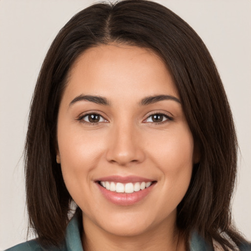 Joyful white young-adult female with long  brown hair and brown eyes