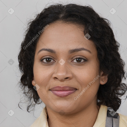 Joyful black young-adult female with long  brown hair and brown eyes