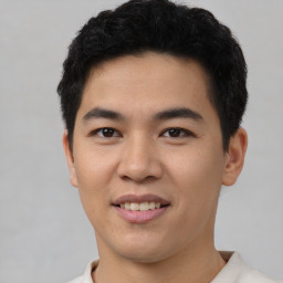 Joyful asian young-adult male with short  black hair and brown eyes