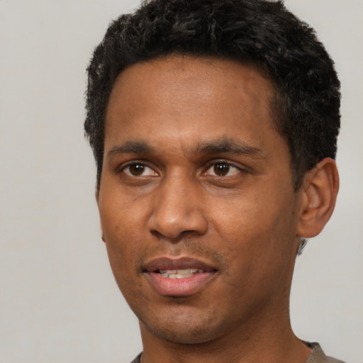 Joyful latino adult male with short  black hair and brown eyes