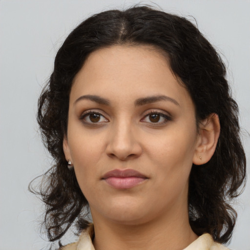 Joyful latino young-adult female with medium  brown hair and brown eyes