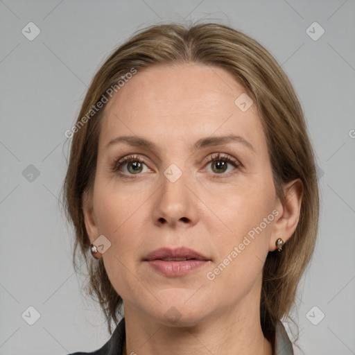 Joyful white adult female with medium  brown hair and grey eyes