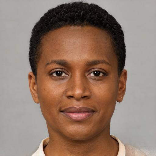 Joyful black young-adult female with short  brown hair and brown eyes