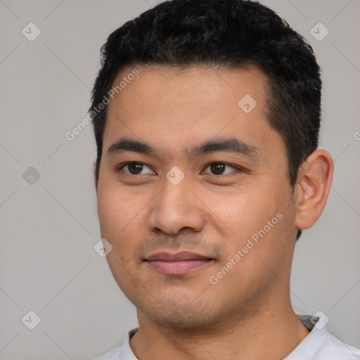 Joyful latino young-adult male with short  black hair and brown eyes