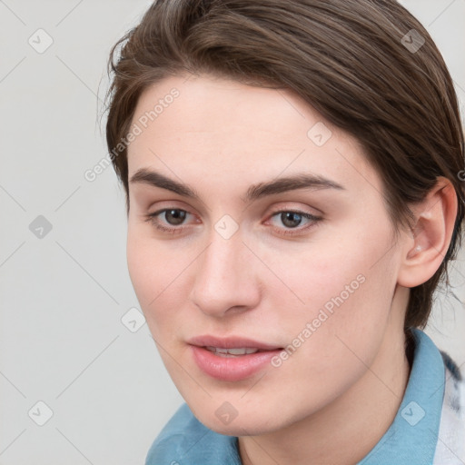 Joyful white young-adult female with medium  brown hair and blue eyes