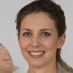 Joyful white adult female with medium  brown hair and brown eyes