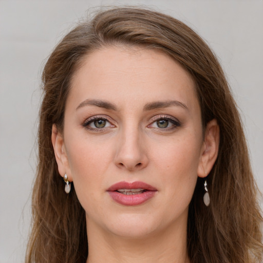 Joyful white young-adult female with long  brown hair and grey eyes