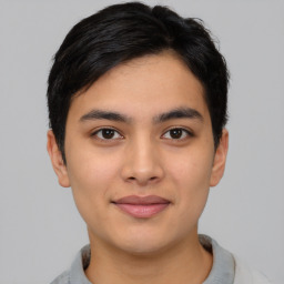 Joyful asian young-adult male with short  black hair and brown eyes