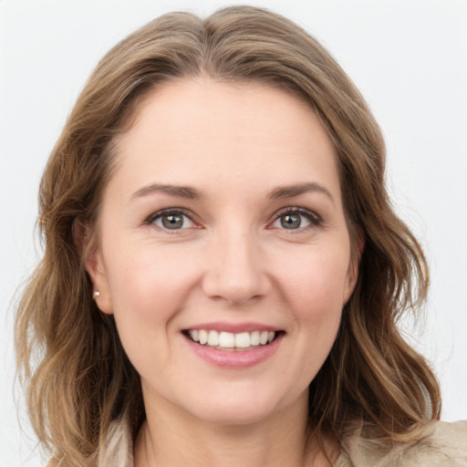 Joyful white young-adult female with medium  brown hair and green eyes