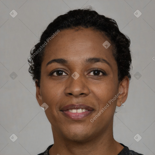 Joyful black young-adult female with short  black hair and brown eyes