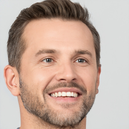 Joyful white adult male with short  brown hair and brown eyes