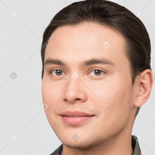 Joyful white young-adult male with short  brown hair and brown eyes