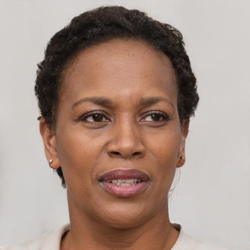 Joyful latino adult female with short  brown hair and brown eyes