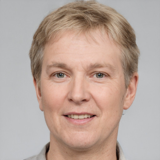 Joyful white adult male with short  brown hair and grey eyes