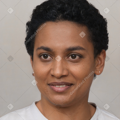 Joyful black young-adult female with short  black hair and brown eyes